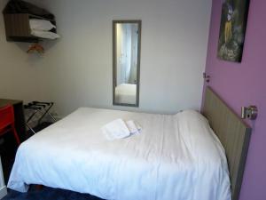 圣阿韦尔坦费桑酒店的卧室配有一张带镜子的白色床
