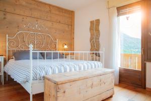 圣博沃Casa Fiore CIPAT 22038的卧室配有白色的床和木墙