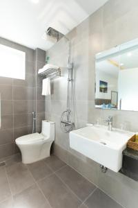 归仁QUE HUONG HOTEL的一间带水槽、卫生间和镜子的浴室