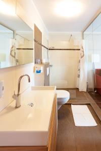 瓦勒湖畔诺伊马克特荷索度假酒店的一间带水槽和卫生间的浴室
