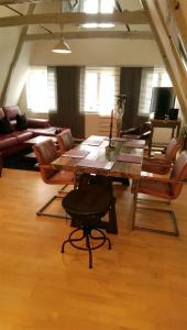 吕贝克Babette Apartments的客厅配有木桌和椅子