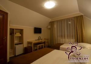 科瓦斯纳Casa din Parc的酒店客房配有两张床和一张书桌