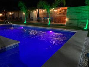 拉佩德雷拉La Posada de la Pedrera的夜晚的游泳池,灯光蓝色