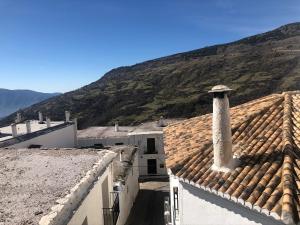卡皮雷拉乡村日尔德浦克尔酒店的享有建筑屋顶和山脉的景色