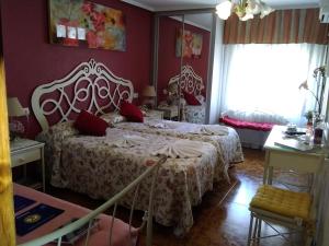 夫罗米斯塔卡密诺圣地亚哥旅馆的一间卧室配有红色墙壁的床