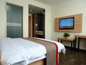 南通尚客优酒店江苏南通通州区先锋镇凯豪广场店的一间卧室配有一张床和一台平面电视