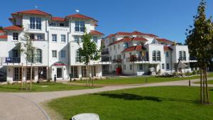 巴贝Zum Inselparadies, Haus Meeresblick的公园里一群白色的大建筑