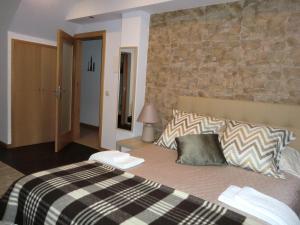 塞亚Retiro da Estrela的一间卧室设有一张带石墙的大床
