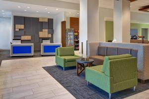 加尔维斯敦Holiday Inn Express & Suites - Galveston Beach, an IHG Hotel的大堂设有两把椅子和一张沙发