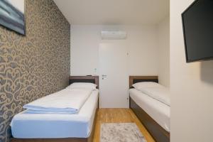 维也纳MyApartments Vienna的墙上的房间里设有两张床