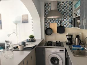 福恩吉罗拉Apartamento Trinidad mit Netflix的厨房配有洗衣机和水槽