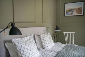 维斯比林德花园酒店的一间卧室配有带枕头和台灯的床