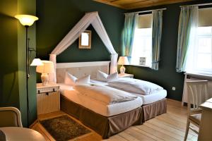 克罗纳赫迪尔库纳赫尔斯塔德特酒店的一间位于绿色客房内的卧室,配有一张床