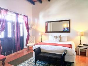 圣胡安圣胡安拉特拉扎酒店的卧室配有一张壁挂镜子的床