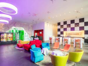 巴塞尔巴塞尔宜必思尚品酒店的大堂设有色彩缤纷的桌椅和酒吧