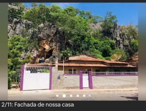 邦热苏斯-达拉帕casa pedacinho do morro的山前有紫色门的建筑