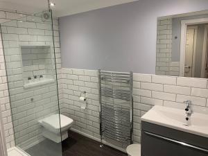 格拉斯哥Flat One, 212 Eaglesham Road, East Kilbride, Glasgow的浴室配有卫生间、盥洗盆和淋浴。