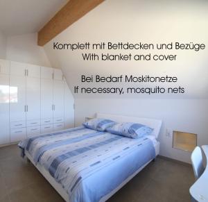 厄赫宁根Passivhaus 750m vom Bodensee -- 2x E-bike inklusive -- Neubau 2019 am Ortsrand的一间卧室配有一张蓝色床单