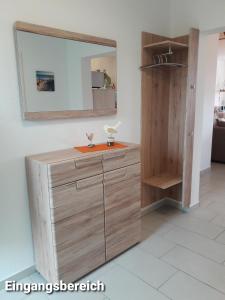佩讷明德Haus Am Peenestrom的浴室设有木制梳妆台和镜子