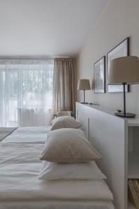 希奥利艾Sun City Apartment的一间白色卧室,配有两张床和窗户