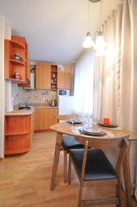 纳尔瓦Grafovi Apartments的一间带木桌的厨房和一间餐厅