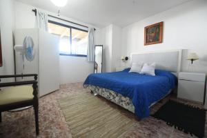 拉帕洛马Estrella de Mar的一间卧室设有蓝色的床和窗户。