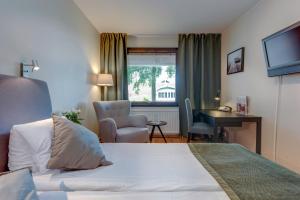 尤城Hotel Bellevue的酒店客房配有一张床、一张桌子和一把椅子。