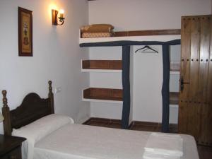 El AlmiceránCortijo El Rey的一间卧室配有两张床和一张蓝色双层床。
