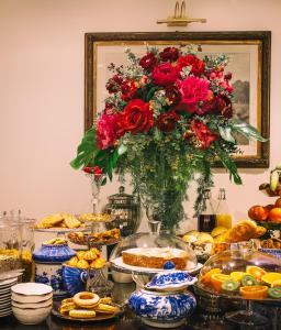 圣玛格丽塔-利古雷乔兰达酒店的一张装满红玫瑰花瓶的桌子