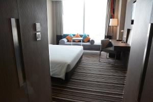 暖武里府曼谷诺富特因帕特酒店的酒店客房,配有床和沙发
