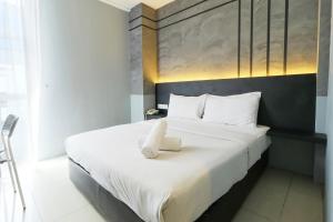 吉隆坡Suite Dreamz Hotel的一间卧室配有一张带白色毛巾的床