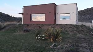 本塔纳山村Lugar de PAZ en las Sierras的山丘上带两扇窗户的房子