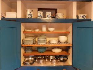 BarreirosCasas da Azenha do Rio的装满碗碟的蓝色橱柜