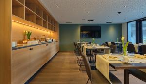 苏斯坦Links Leuk Golfresort的餐厅内带桌椅的用餐室