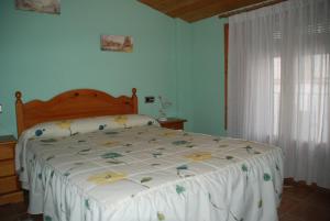 贝塞特Casa La Catalina的卧室配有一张带白色棉被的床和窗户。