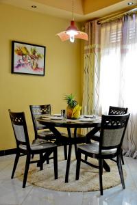 LuziraLake View Apartments的一间用餐室,配有黑色的桌子和椅子