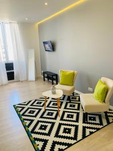蓬塔德尔加达Urban Apart - Azores的客厅配有两把椅子和地毯。