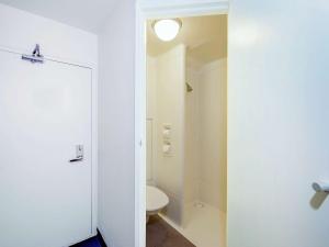 悉尼恩菲尔德宜必思快捷酒店的一间带卫生间和白色门的浴室