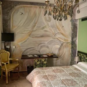 阿尔巴洛卡达特洛奥巴旅馆的一间卧室配有一张壁画床