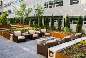 西雅图EVEN Hotel Seattle DTWN Lake Union, an IHG Hotel的一个带桌椅和火坑的庭院