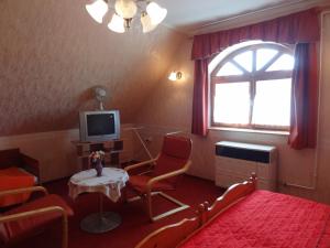 下帕霍克兹索利旅馆的一间卧室配有一张床、一张桌子和一台电视。