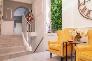 佛罗伦萨蒂多精品酒店的客厅配有黄色椅子和桌子