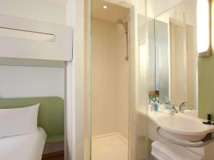 图尔图尔北宜必斯廉价酒店的一间带水槽、淋浴和卫生间的浴室