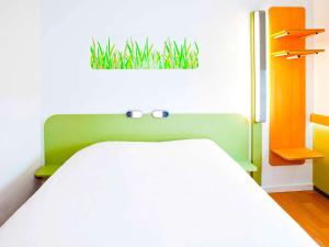 梅斯梅兹中心宜必思快捷酒店的卧室配有一张挂在墙上的植物床