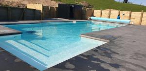 托科罗阿5 Acres B&B的庭院里的一个蓝色海水大型游泳池