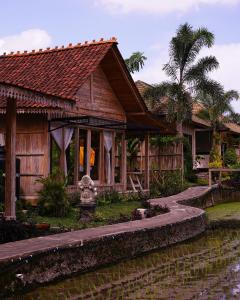 乌布Kidem Ubud Villas的前面有一条运河的木屋