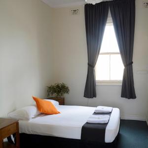 TemoraShamrock Hotel Motel Temora的一间卧室设有两张床和窗户。