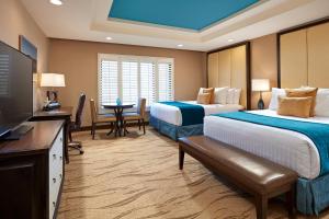 圣地亚哥Empress Hotel La Jolla的酒店客房设有两张床和一台平面电视。