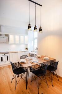 塔尔图Lossi 32 Lux Apartment的厨房配有木桌和椅子