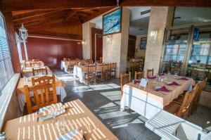 普拉森西亚Hostal La Despensa de Extremadura的空的饭厅,配有桌椅